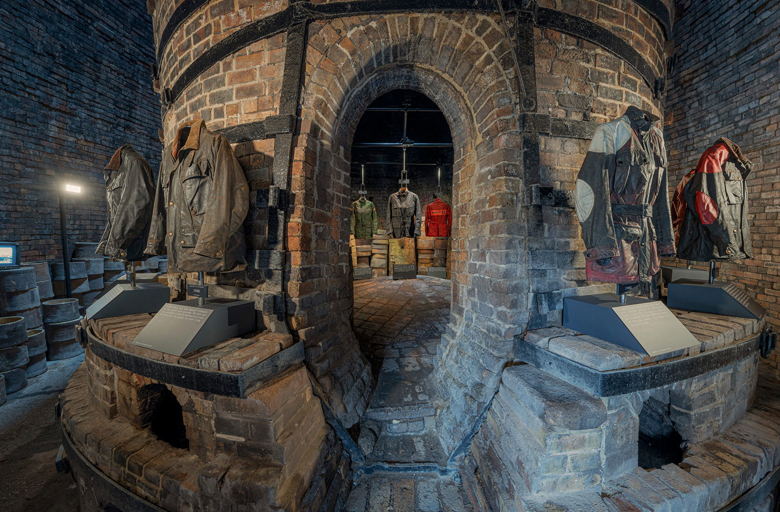 View from outside to inside the kiln where various Belstaff jackets can be seen hanging up as part of the exhibition.